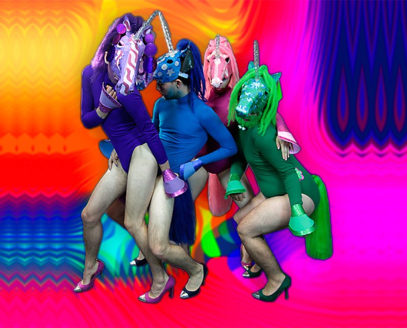 Four people in unicorn masks and leotards, with high heels and horse tails, against a vibrant, swirling background.