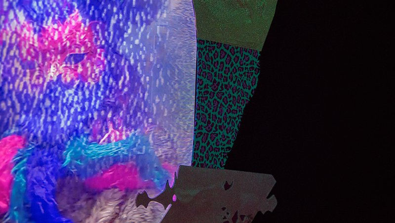 Abstract image with a vibrant blue and pink textured left side, a green leopard print pattern on the right, and a black backg