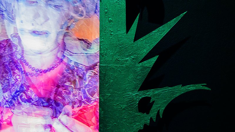 Abstract digital art, split image. Left: distorted portrait in pink, purple, and white. Right: textured green spikes on black