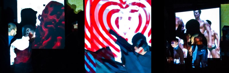 Three screens show abstract red and white patterns, a heart, and men in briefs, with dark silhouettes of viewers.