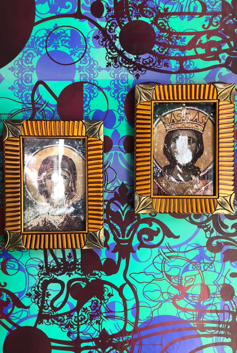 Two distressed icons in ornate gold frames on a vibrant teal and purple patterned background.