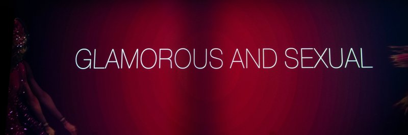 White text "GLAMOROUS AND SEXUAL" on a dark red background with blurred figures on the left and right edges.